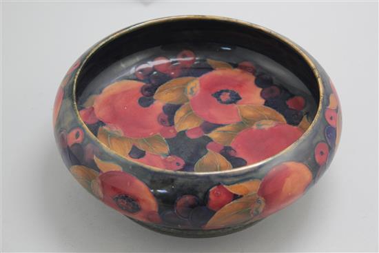 A William Moorcroft pomegranate pattern Tudric pewter mounted bowl, c.1920, 22cm, mount loose